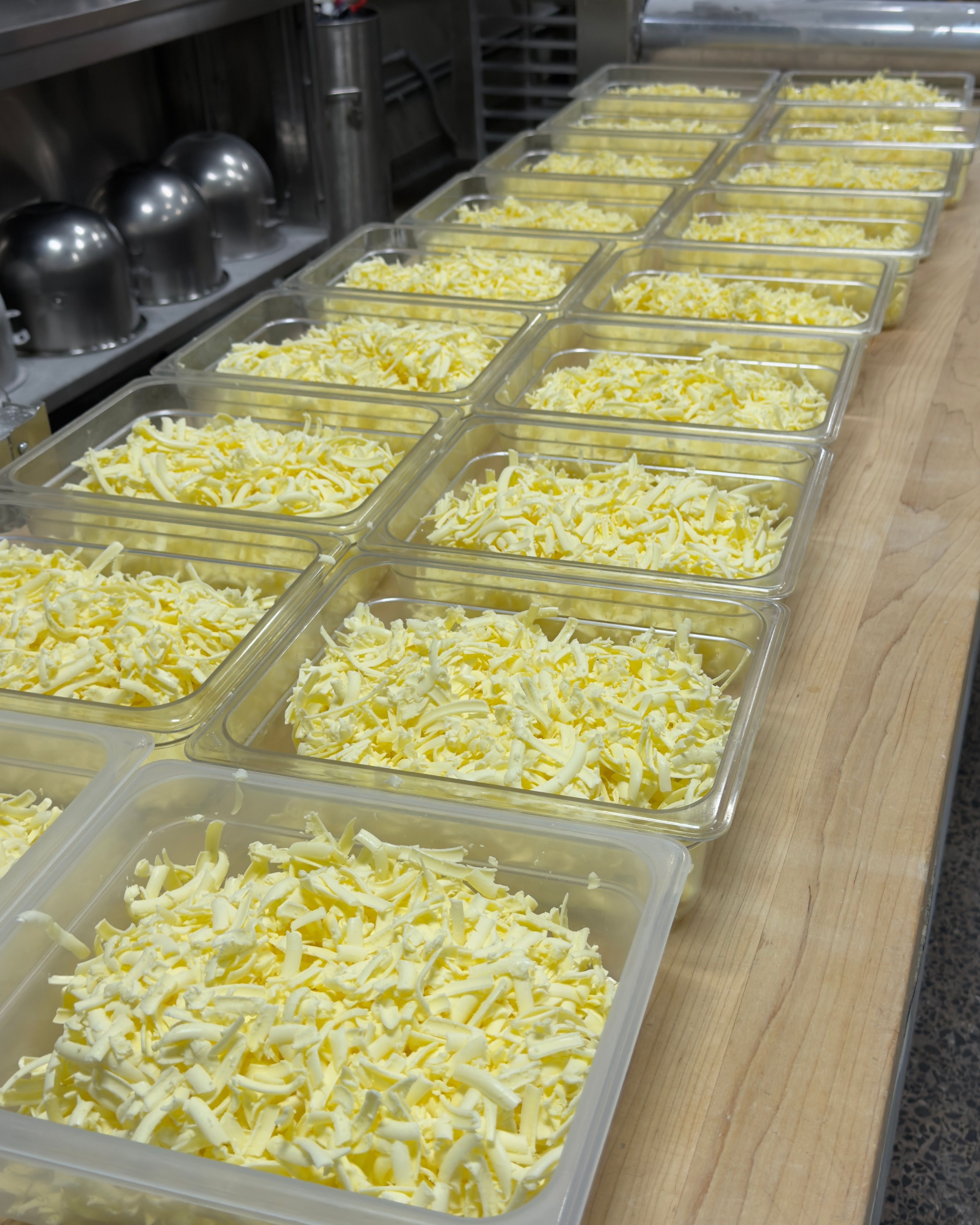 Containers of butter, shredded, portioned and ready for scone production.