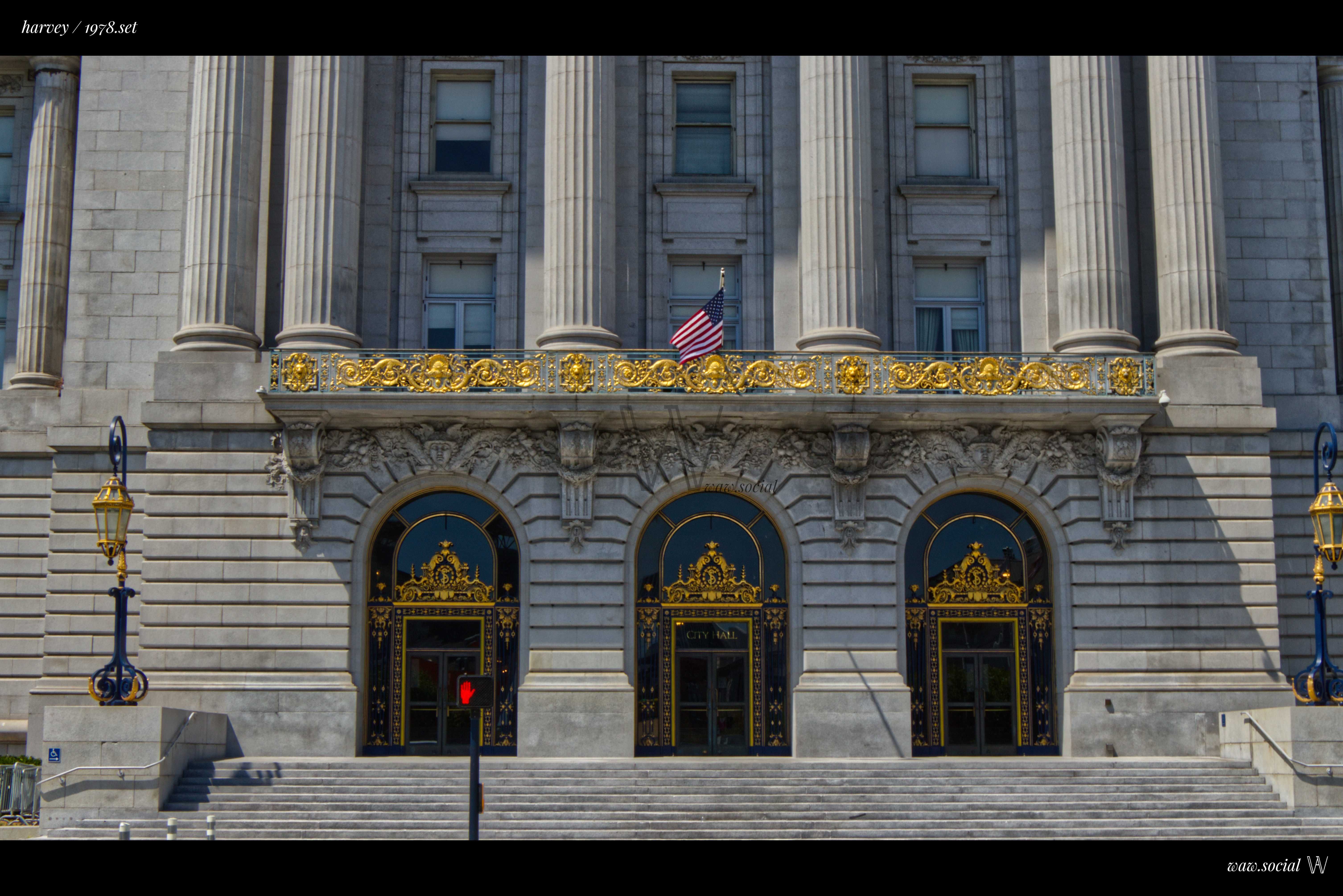 A cinematic warm color photo of San Francisco City Hall in California with a US flag in front.