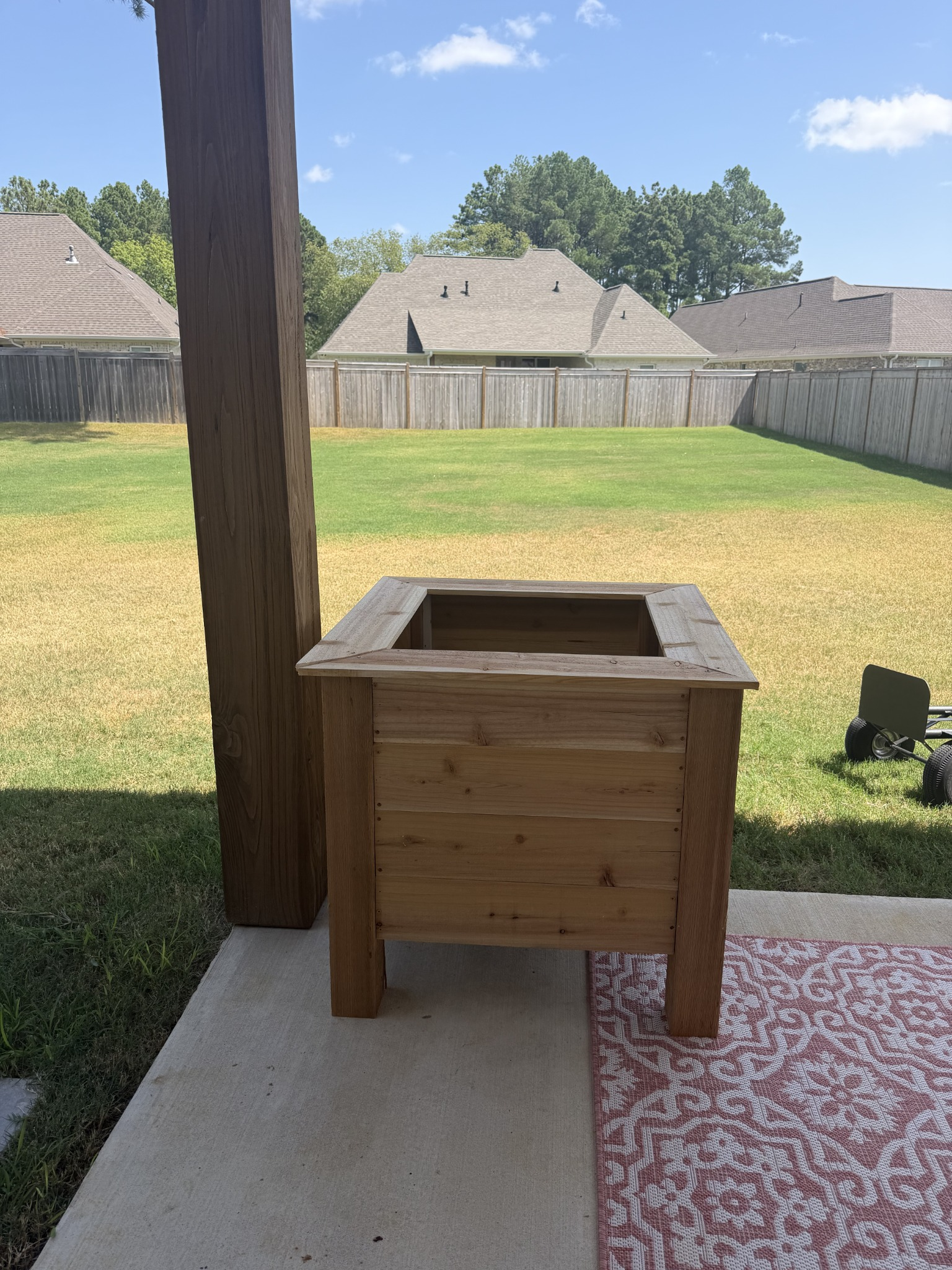 Unplanted wooden planter on the porch